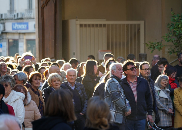 Foule de personnes entrant dans la cour de l'hôtel-Dieu avec coucher de soleil